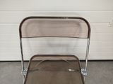 a clear plastic chair with a metal frame