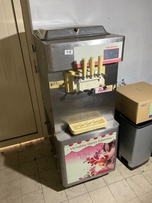 une machine posée sur le sol à côté d'une poubelle