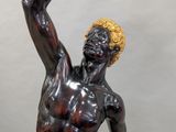 statue of a man holding a ball in his hand
