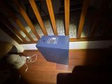 a blue box sitting on the floor next to a chair