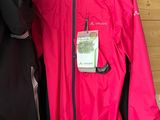 two women ' s jackets hanging on a rack in a clothing store
