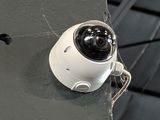 two cameras mounted on the side of a building
