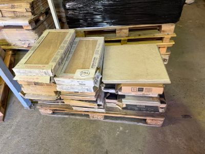 several stacks of boxes of wood sit on pallets in a warehouse
