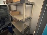 a shelf that has some boxes on it in a room