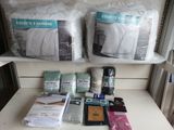a shelf with a lot of bedding and pillows on it