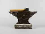 an iron anvil with a hammer on top of it