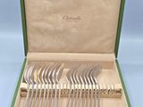 a set of silverware in a green case with handles