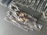 a lot of spoons and forks wrapped in plastic bags