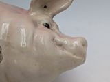 a ceramic pig that is sitting on a table