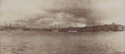 a black and white photo of a harbor with ships in the water
