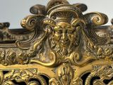 a gold vase with a lion head on it