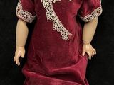 a small doll that is sitting on a black surface