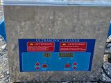 a close up of a metal container with a red button on it