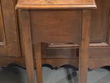 a wooden table with a metal bowl on top of it