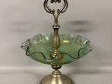 an image of a green glass bowl on a stand with a heart shaped handle