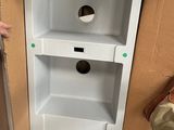 a box with a hole in it and a person standing next to it