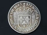 a close up of a silver coin with a crown on it