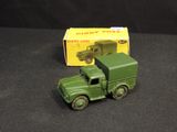 a green toy truck with a yellow box on the back