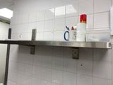 a bathroom with a sink, mirror, and toiletries on the wall