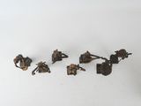 five pieces of metal that are on a white surface