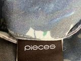 the label of a piece of clothing on the back of a person ' s shirt