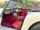 a red and white car with a steering wheel and dashboard