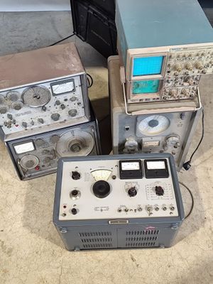 several electronic equipment sitting on top of each other in a room