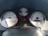 a close up of a car dashboard with gauges and speedometers