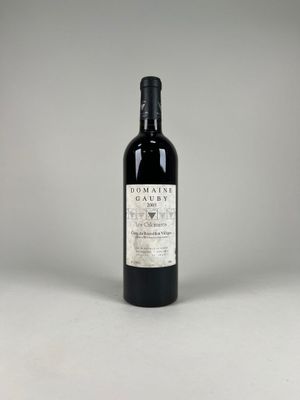 a bottle of wine sitting on top of a white table