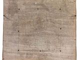 an old wooden board with holes and rivets on it