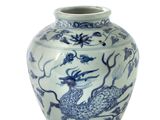 a blue and white vase with a dragon design on it