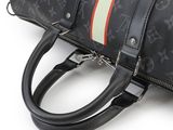 a black purse with a red, white, and green stripe on the side