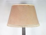 a lamp that has a brown shade on it