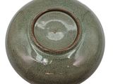 a green vase with a brown rim on a white background