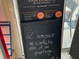 a sign outside of a restaurant with a menu written on it