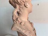 bust of a woman with a flower in her hair