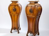 pair of antique wooden pedestals with carvings on top of them