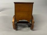 wooden toy car with wheels on a white surface with a white background