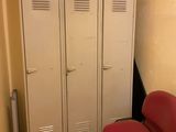 two red chairs in the corner of a room