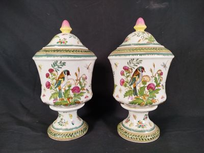 two vases with birds and flowers painted on them on a black background