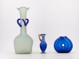 three glass vases sitting next to each other on a table