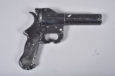 a small gun that is on a white surface