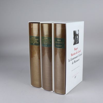three books are stacked on top of each other on a table