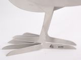 a white bird that is standing on a fork