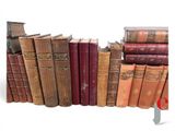 many old books lined up together on a shelf