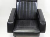 a black leather chair with black legs on a white background