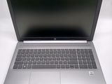 an open laptop computer sitting on top of a white table