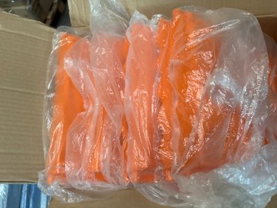 a box of carrots wrapped in plastic on a table