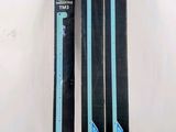 two skis sitting next to each other on a white surface