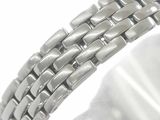 a close up of a silver bracelet on a white surface